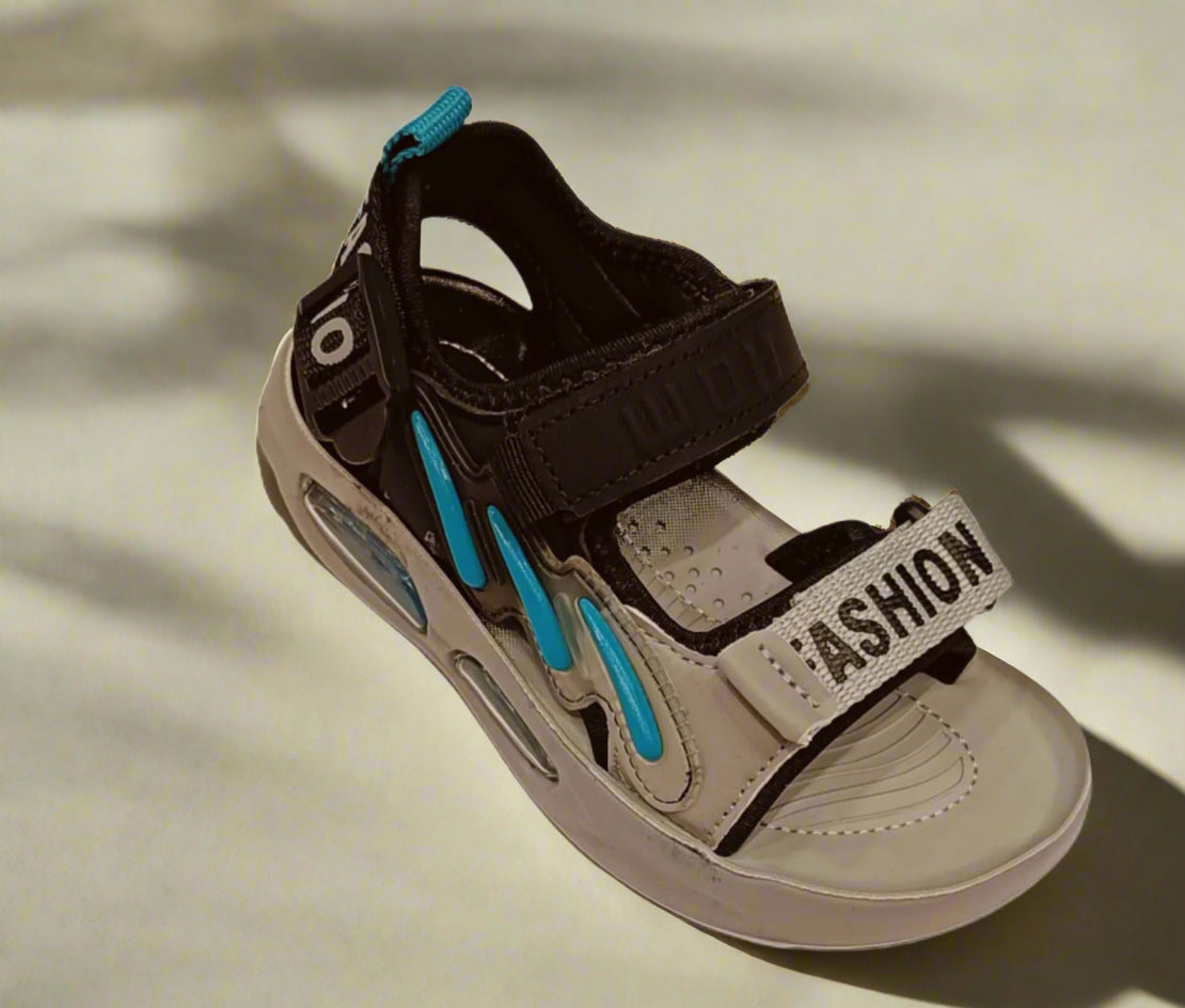 Children's sandal with brown and beige straps on a white background