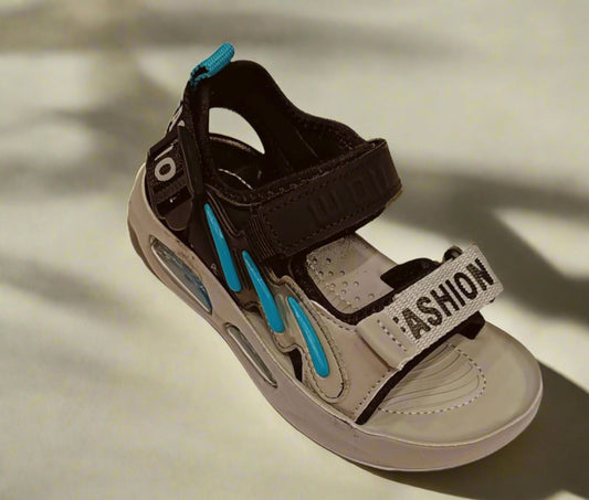 Children's sandal with brown and beige straps on a white background