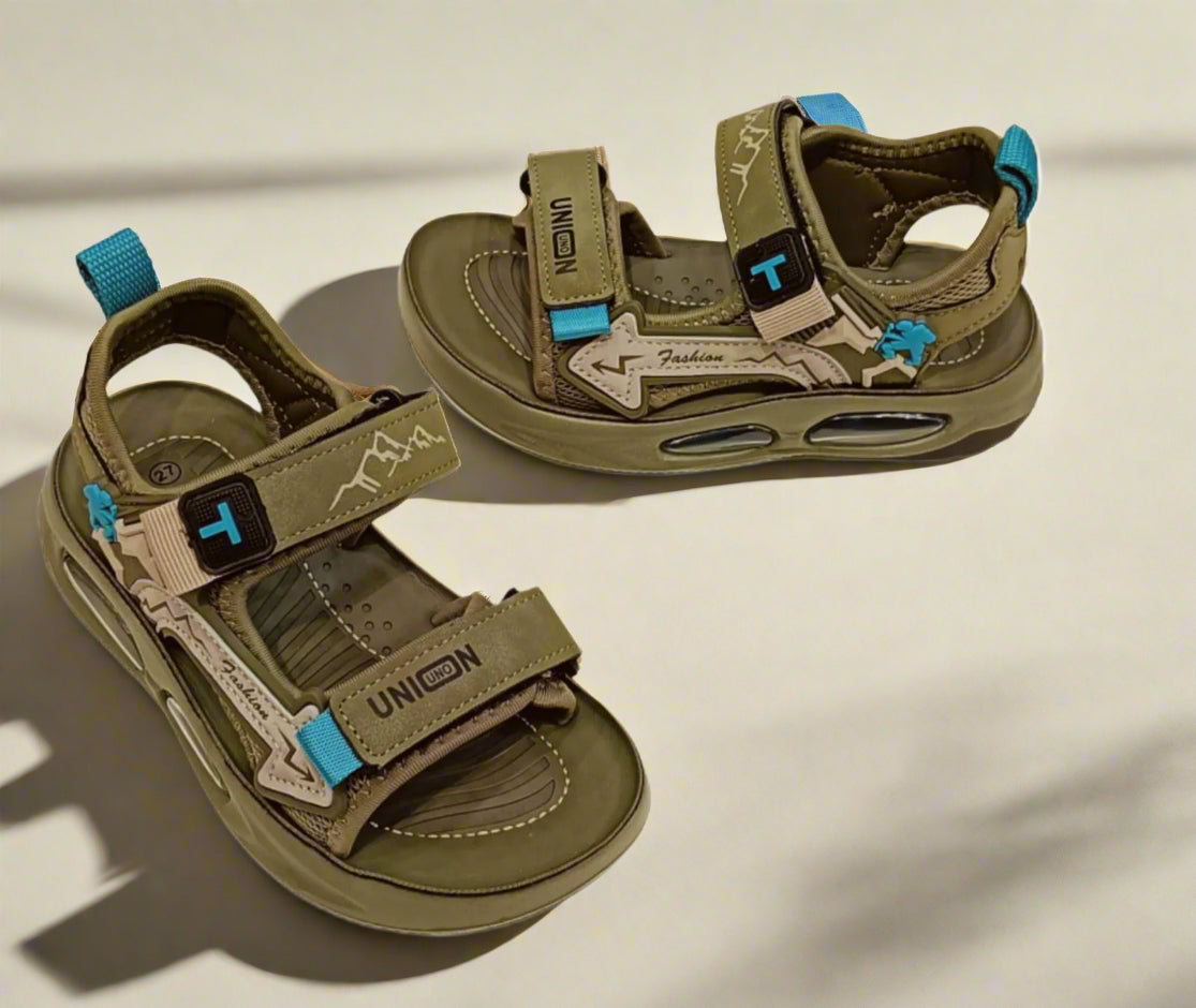 Pair of brown sandals with blue straps on a white background