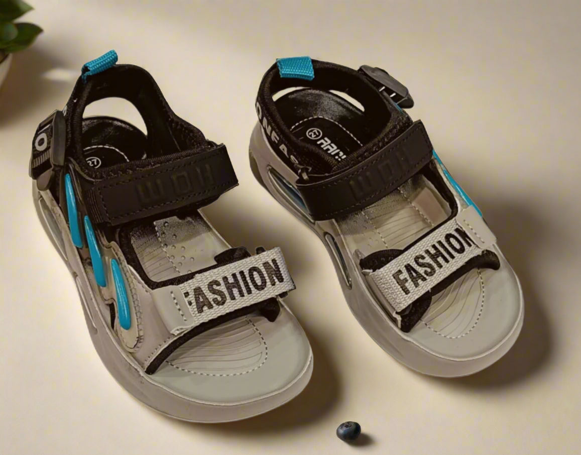 Pair of children's sandals with 'Fashion' text on a white background