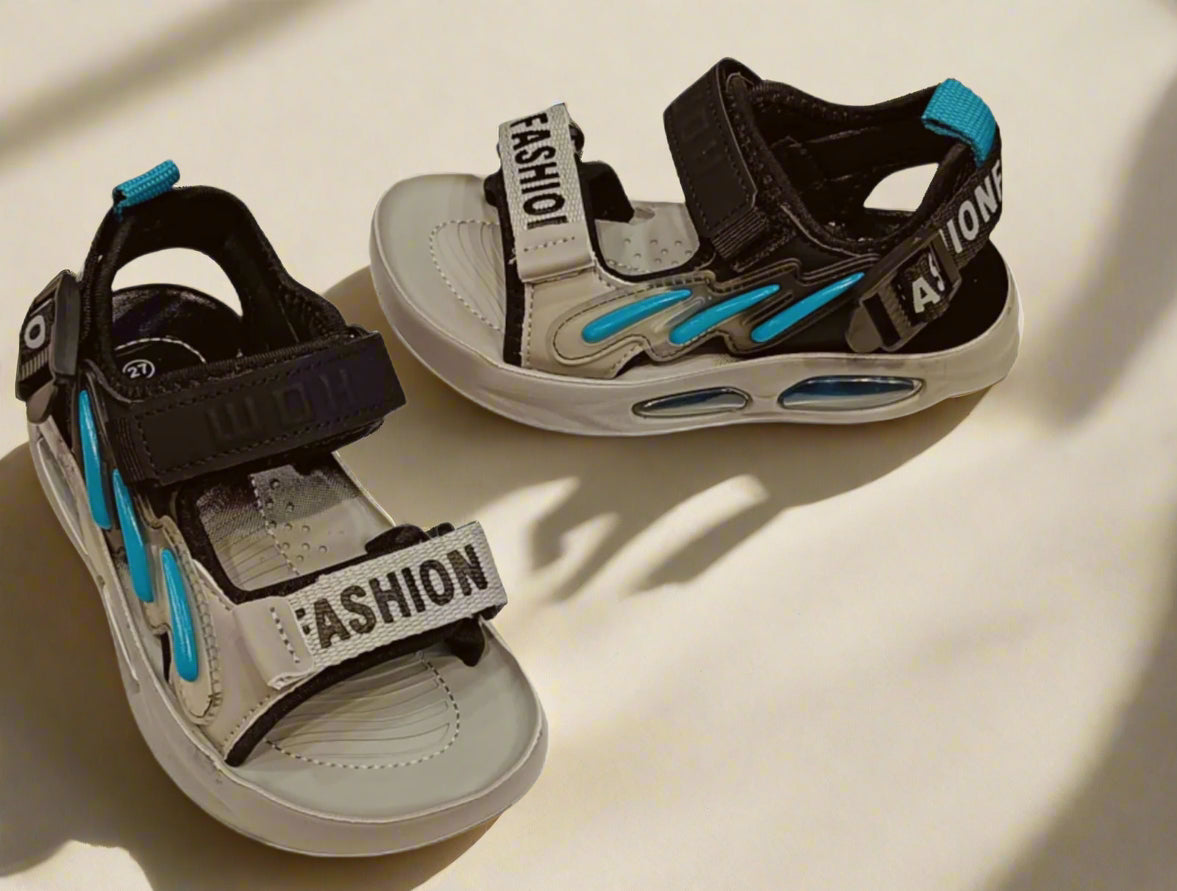 Pair of children's sandals with 'Fashion' strap on a white background